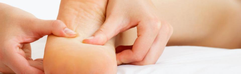 Therapist massaging the sole of a foot